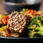 Beef and broccoli stir-fry with sesame ginger sauce in a vibrant bowl.