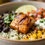 Chipotle-style chicken burrito bowls topped with fresh ingredients and served in a bowl.