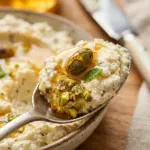 Crispy whipped feta dip topped with honey and pistachios served in a bowl.