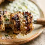 Greek yogurt marinated chicken skewers served with tzatziki sauce