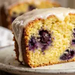 Iced lemon blueberry loaf cake with fresh blueberries and lemon glaze