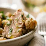 Lemon Herb Tuna and Chickpea Salad garnished with fresh herbs and lemon slices