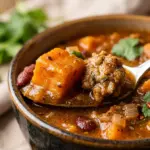 Bowl of Sweet Potato and Turkey Chili garnished with cilantro and spices