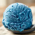 Delicious blue raspberry ice cream in a waffle cone topped with sprinkles