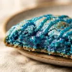 Freshly baked Blue Raspberry Icee Cookies with colorful blue sprinkles