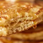 Delicious homemade buttermilk pancakes stacked with syrup on a plate