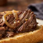 Delicious Crockpot French Dip Sandwiches served with au jus for dipping.