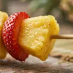 Colorful fruit and marshmallow kabobs served on skewers for a tasty treat.