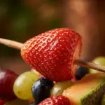 Colorful fruit kabobs displayed on a platter for a party.