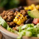 Ground turkey taco bowl prepared for meal prep with fresh vegetables.