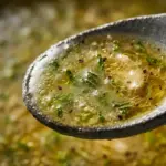 Homemade lime vinaigrette dressing in a glass jar with ingredients