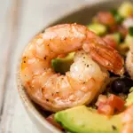 Delicious shrimp taco bowl with fajita-style ingredients and toppings