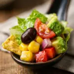 Colorful taco salad with fresh vegetables, beans, and tortilla chips