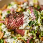 Viral steak salad topped with pickled ranch dressing and colorful vegetables